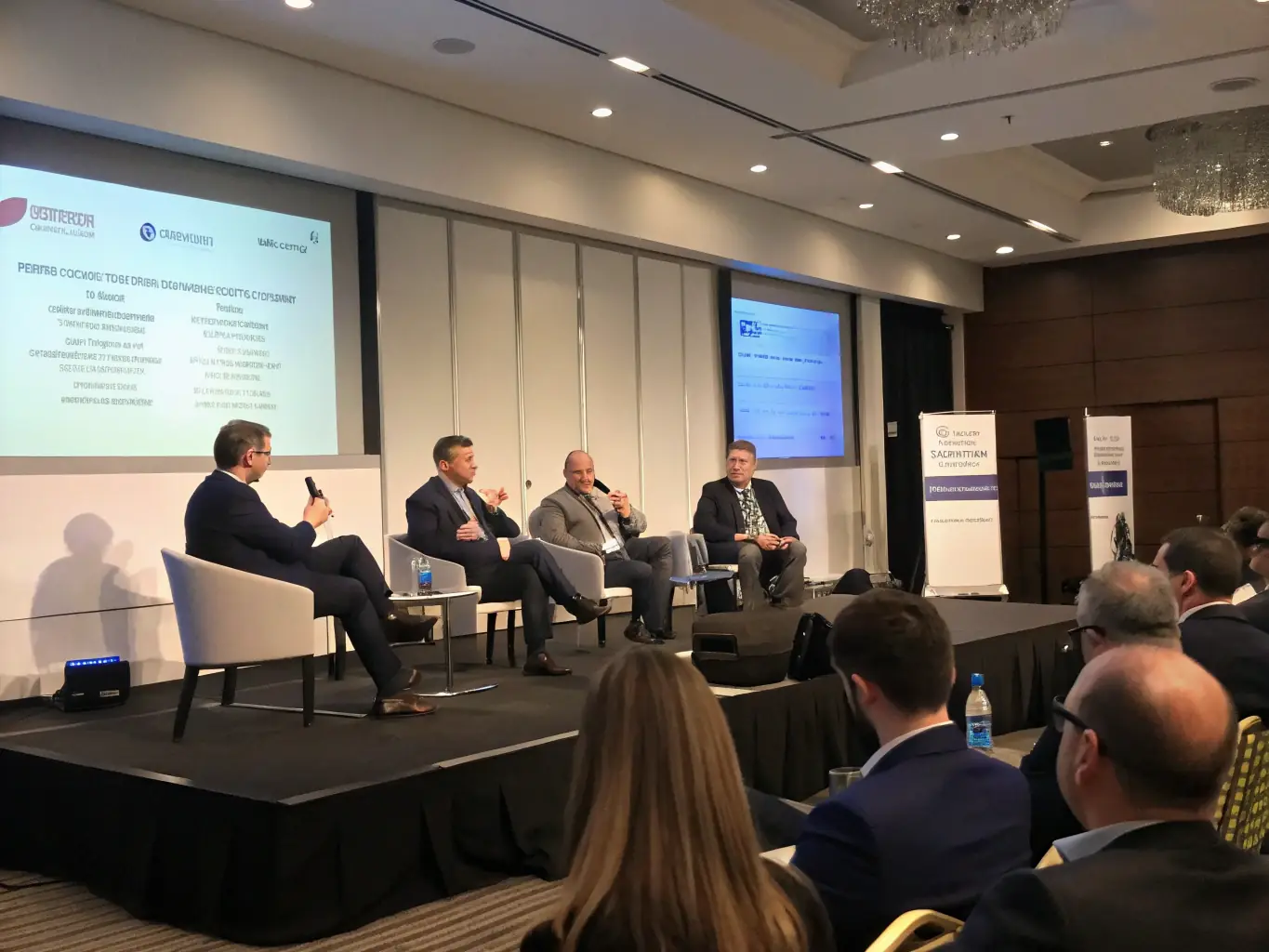An inspiring photograph of a panel discussion at a business conference in Edinburgh, featuring a diverse panel of experts and a captivated audience.